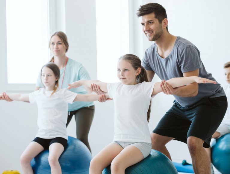 Kids exercising pilates on physcial education classes